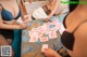 A group of women playing cards on a bed.