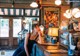 A woman sitting at a bar in a restaurant.