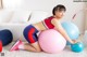 A woman sitting on an exercise ball in a living room.